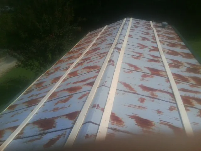 Rusted metal roof panels with new wood purlins before replacement — Storm Damage Roof Repair in Leesville by Roofing Brothers